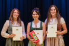 drei Frauen mit Urkunde in der Hand