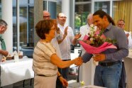 Irmgard Reischl gratuliert den Teilnehmern. Teilnehmer hat Blumenstrauß in der Hand
